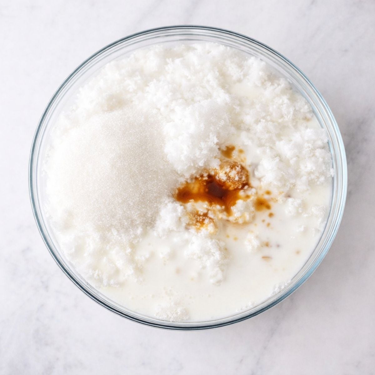 A bowl of snow ice cream ingredients on a countertop