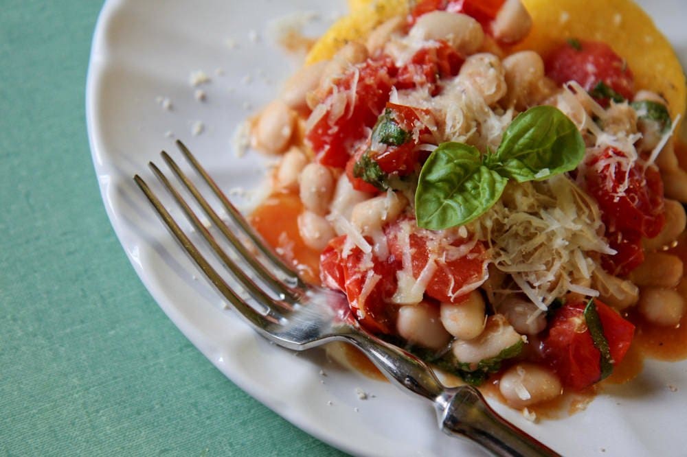 polenta cakes with white beans and tomatoes.