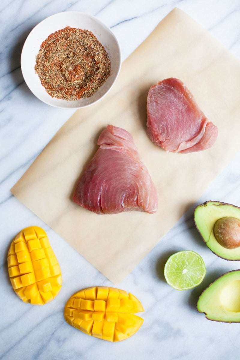 Raw tuna steaks and other ingredients for a grilled tuna steak recipe