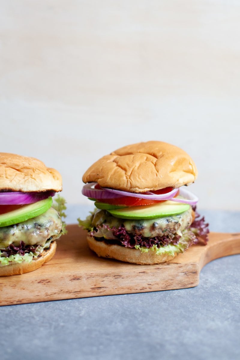 Two Garden Onion Burgers on a wooden cutting board