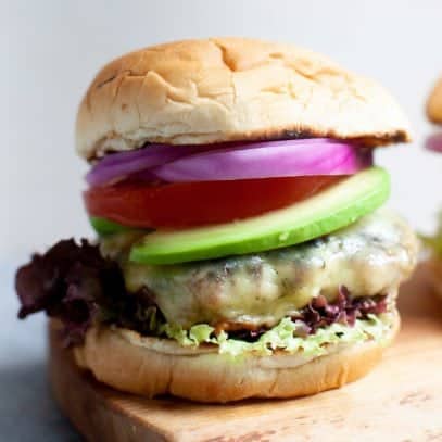 Close-up shot of a Garden Onion Burger on a cutting board
