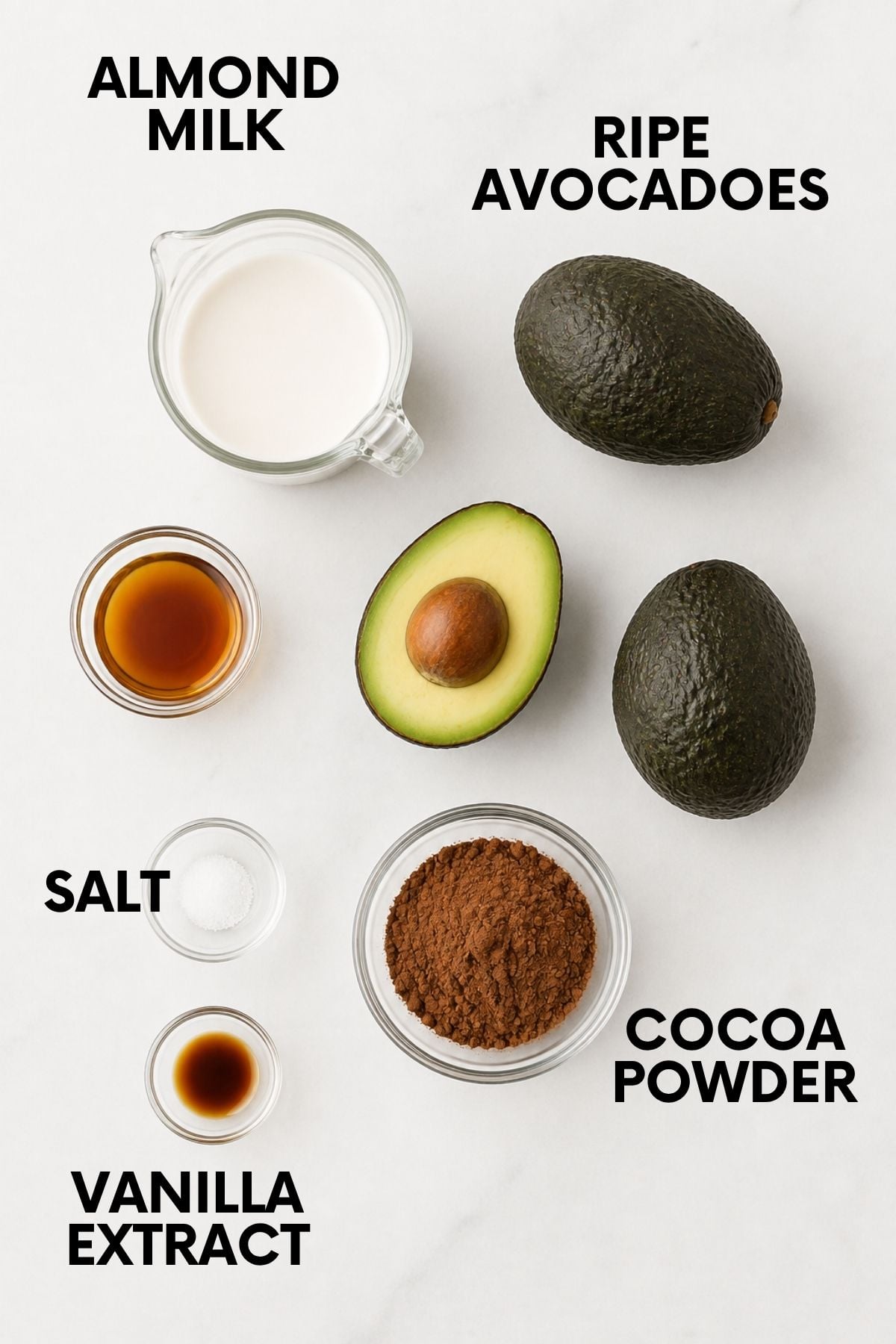Labeled ingredients for an avocado pudding recipe, including almond milk, ripe avocados, cocoa powder, vanilla extract, and salt.