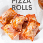 Pizza rolls on a white towel. A text overlay reads "Homemade Pizza Rolls"