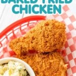 Angled shot of crispy baked fried chicken in a basket with potato salad