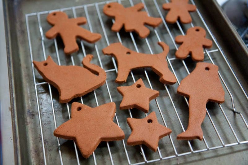 Gingerbread ornaments cool on a wire rack.