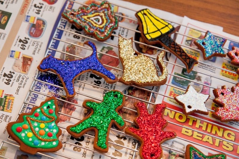 Decorated cinnamon ornaments lay on newspaper to dry