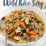 Cream of Turkey and Wild Rice Soup in a white bowl with a spoon. Text overlay reads "Turkey and Wild Rice Soup"