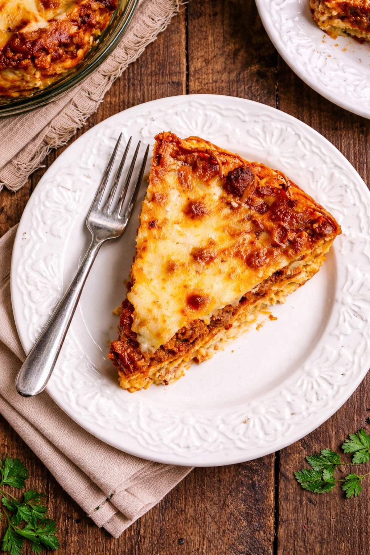 A slice of spaghetti pie on a white plate