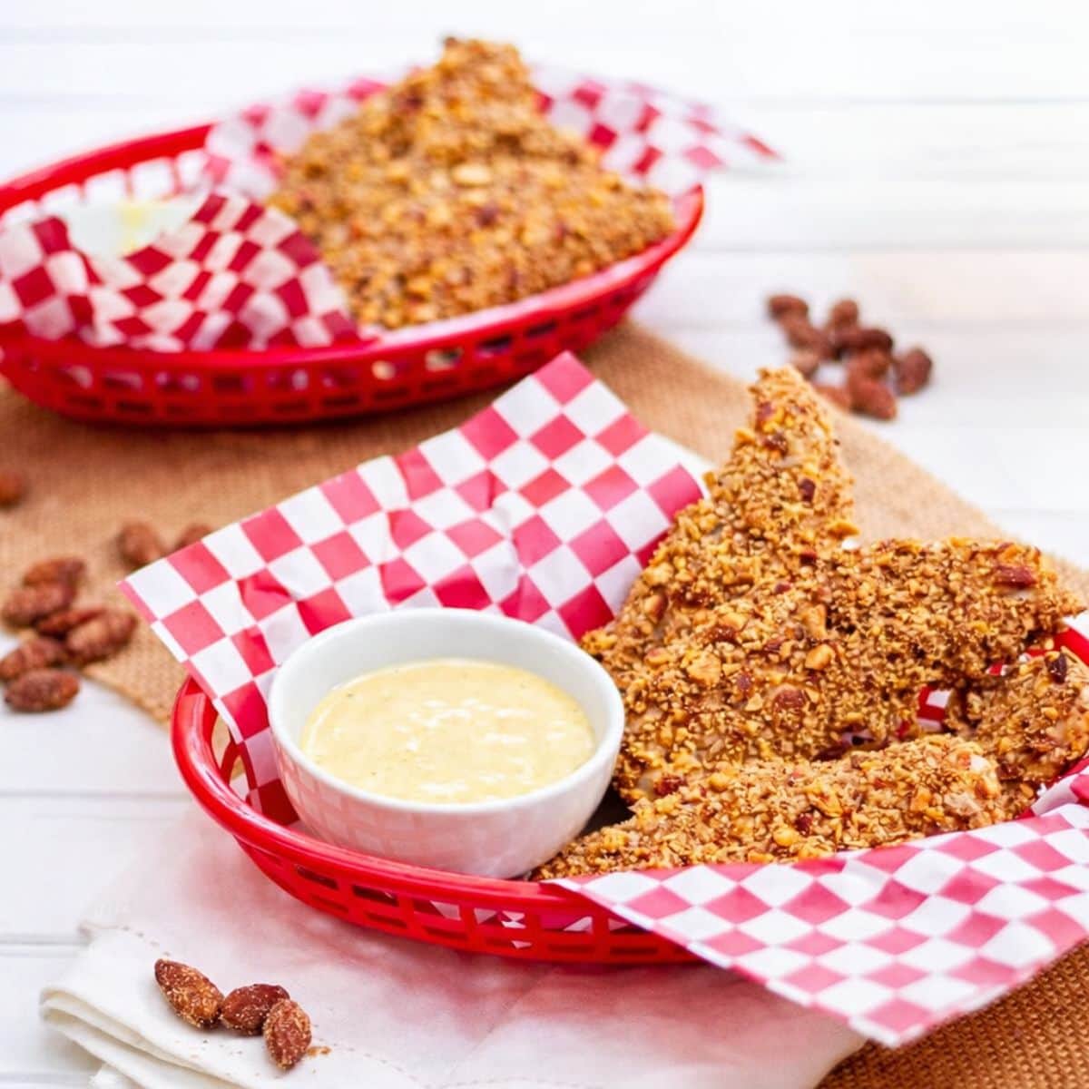 Almond crusted chicken strips in baskets on a table
