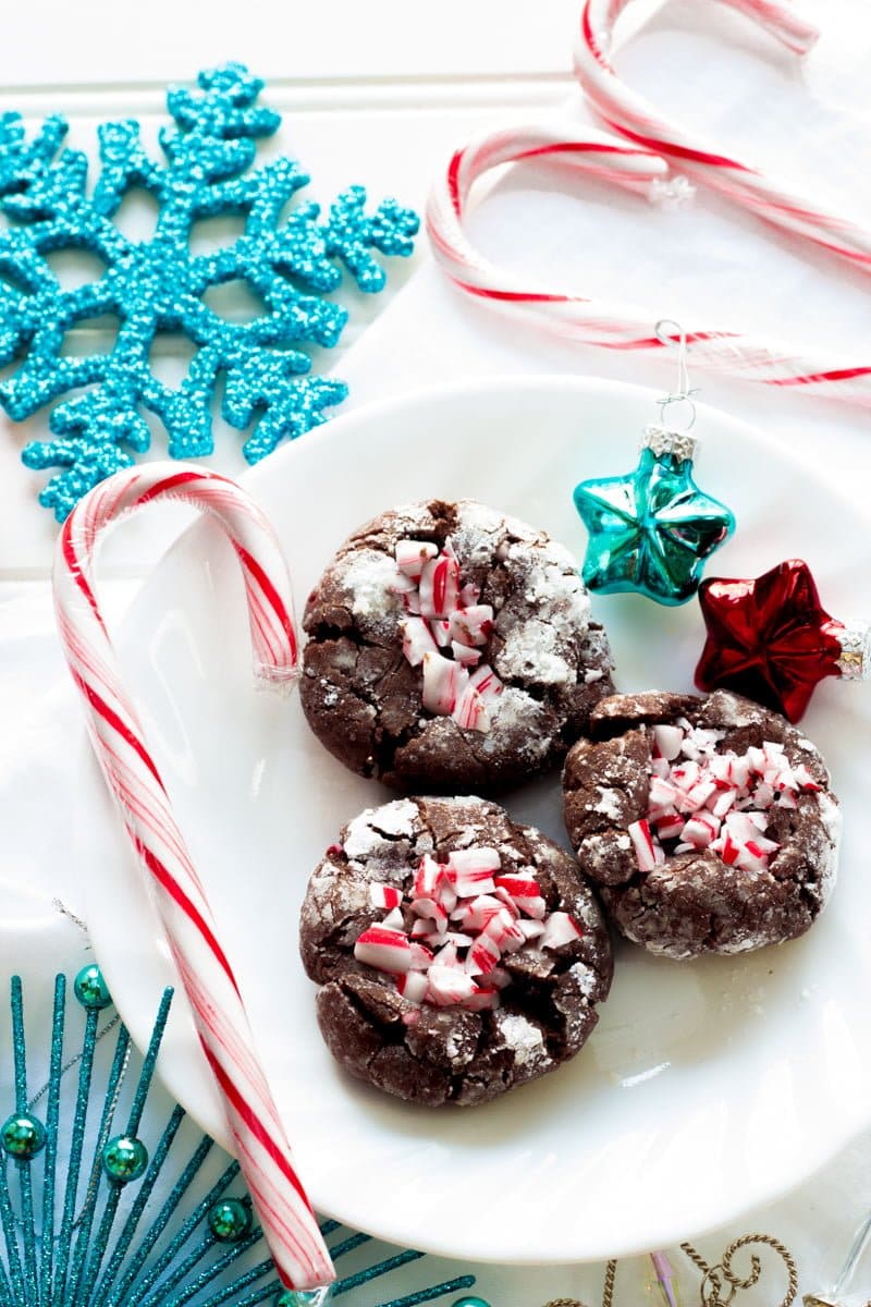 Chocolate cookies with crushed candy canes on top on a white plate