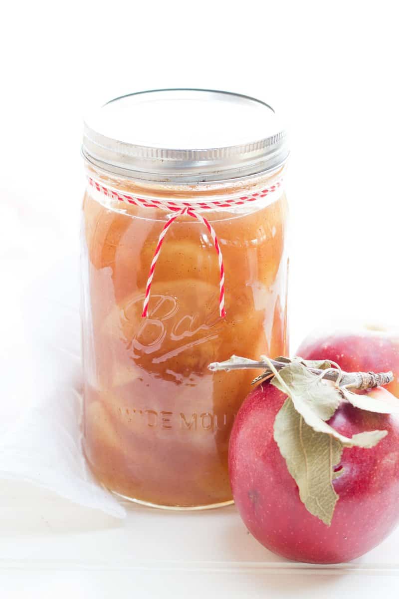 Bourbon-Vanilla Bean Apple Pie Filling with an apple. Preserves like this one make great Christmas food gifts!