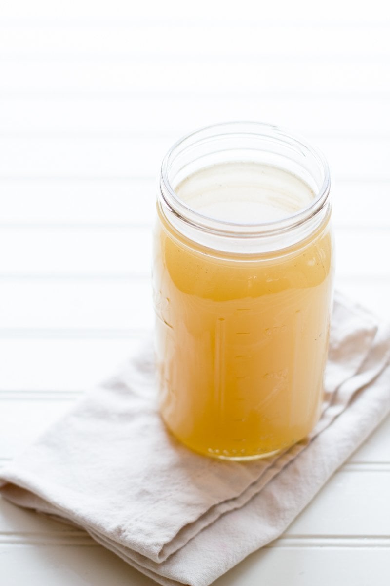 Chicken Bone broth in jar on a napkin.