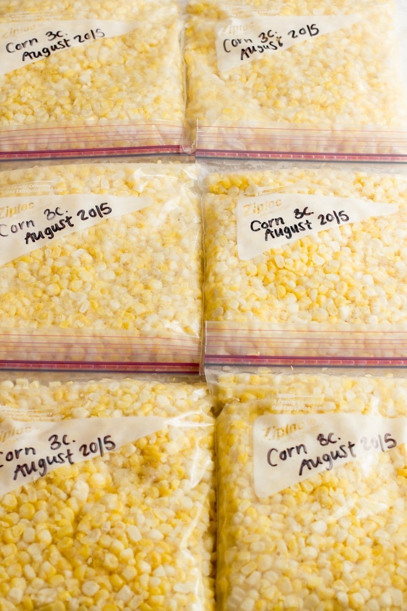 Three rows of zip-top bags filled with fresh corn kernels.