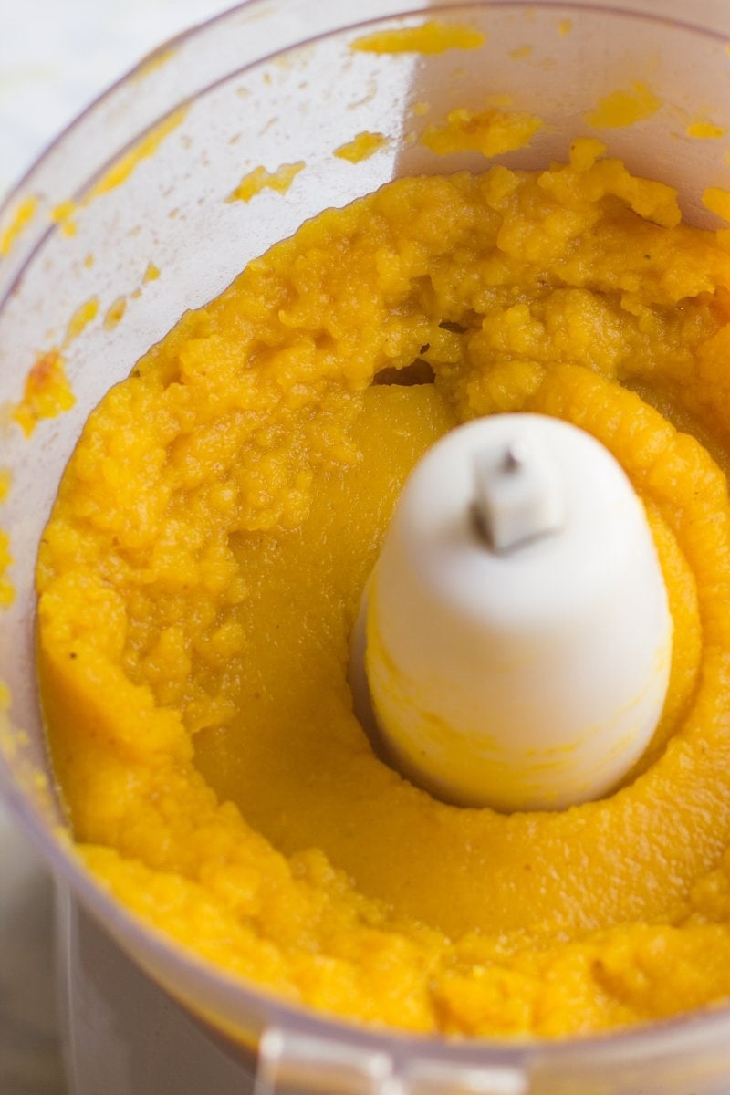 Close view of homemade pumpkin puree in a food processor.