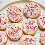 Lofthouse Sugar Cookies with pink icing and rainbow sprinkles on a plate