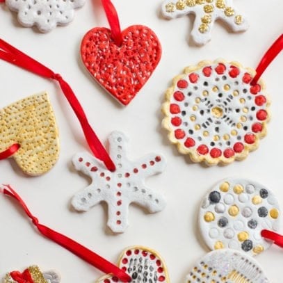 Salt Dough Ornaments painted white, red, silver, and gold lay on a white background.