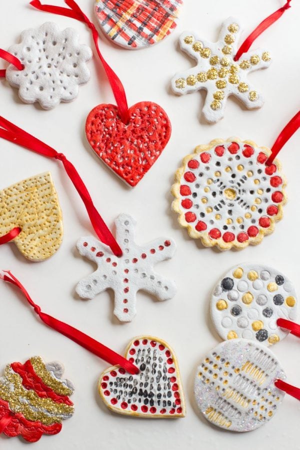 Salt Dough Ornaments painted white, red, silver, and gold lay on a white background.