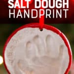 A baby's handprint in a white salt dough ornament hangs from a red ribbon. A text overlay reads "How to Make a Salt Dough