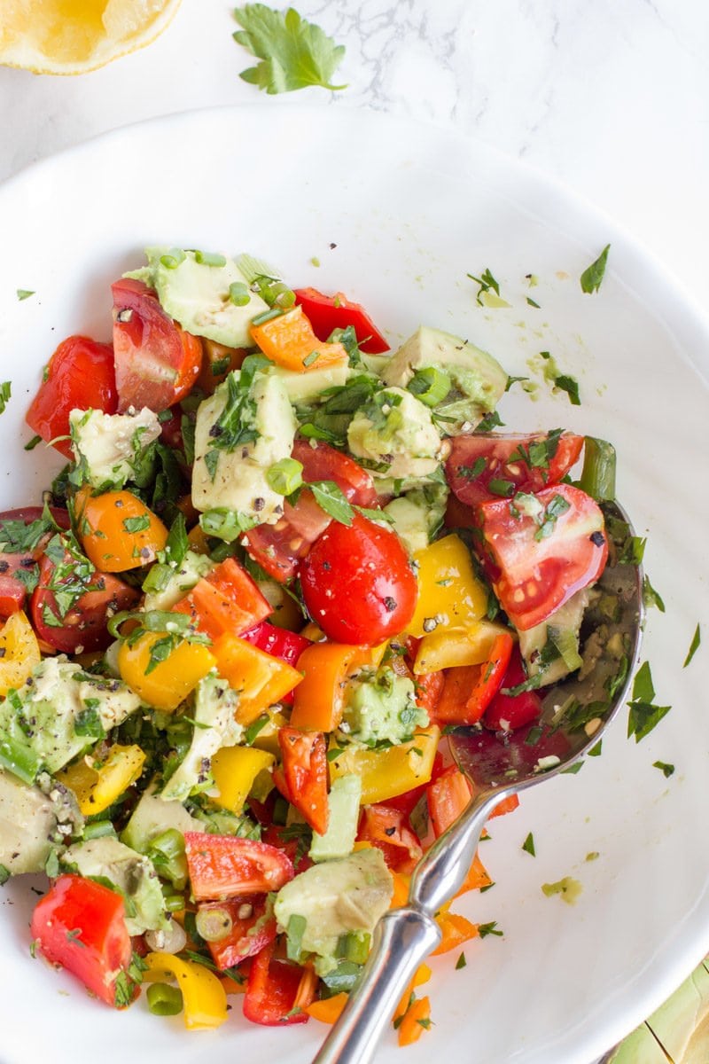 The final Avocado Bell Pepper Salad is mixed together in a white bowl