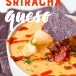 Blue corn tortilla chip dipping into a white bowl of queso drizzled with sriracha. A text overlay reads "Bacon & Sriracha Queso."