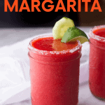 A canning jar used as a drinking glass is rimmed with salt and filled with frozen strawberry cucumber margarita. A text overlay reads "Frozen Strawberry Margaritas
