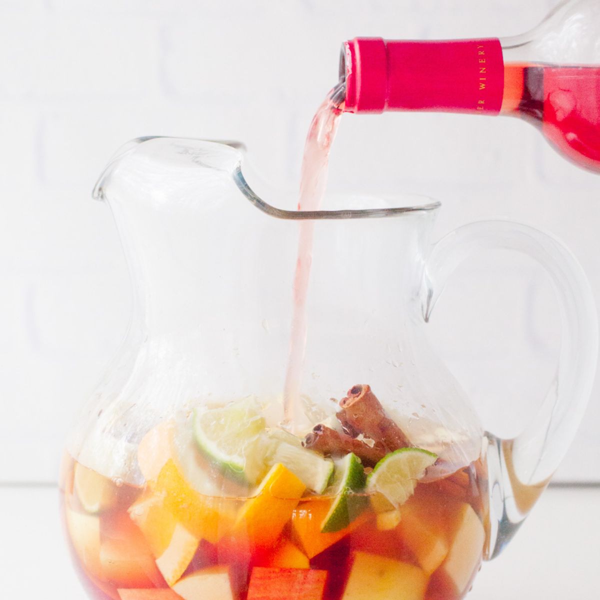 Pouring wine into a pitcher of sangria