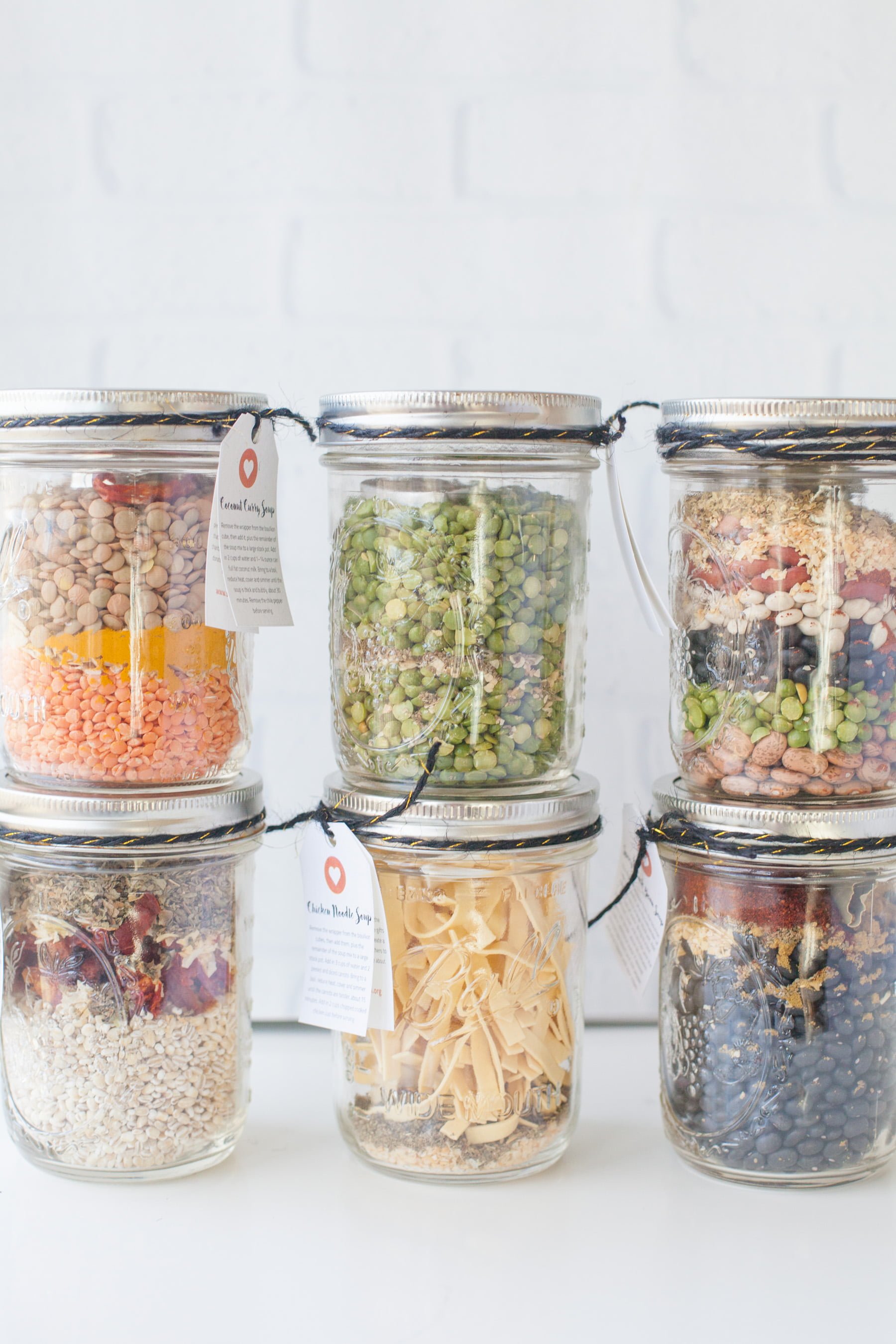 Six jars filled with dry ingredients stacked in two rows of three
