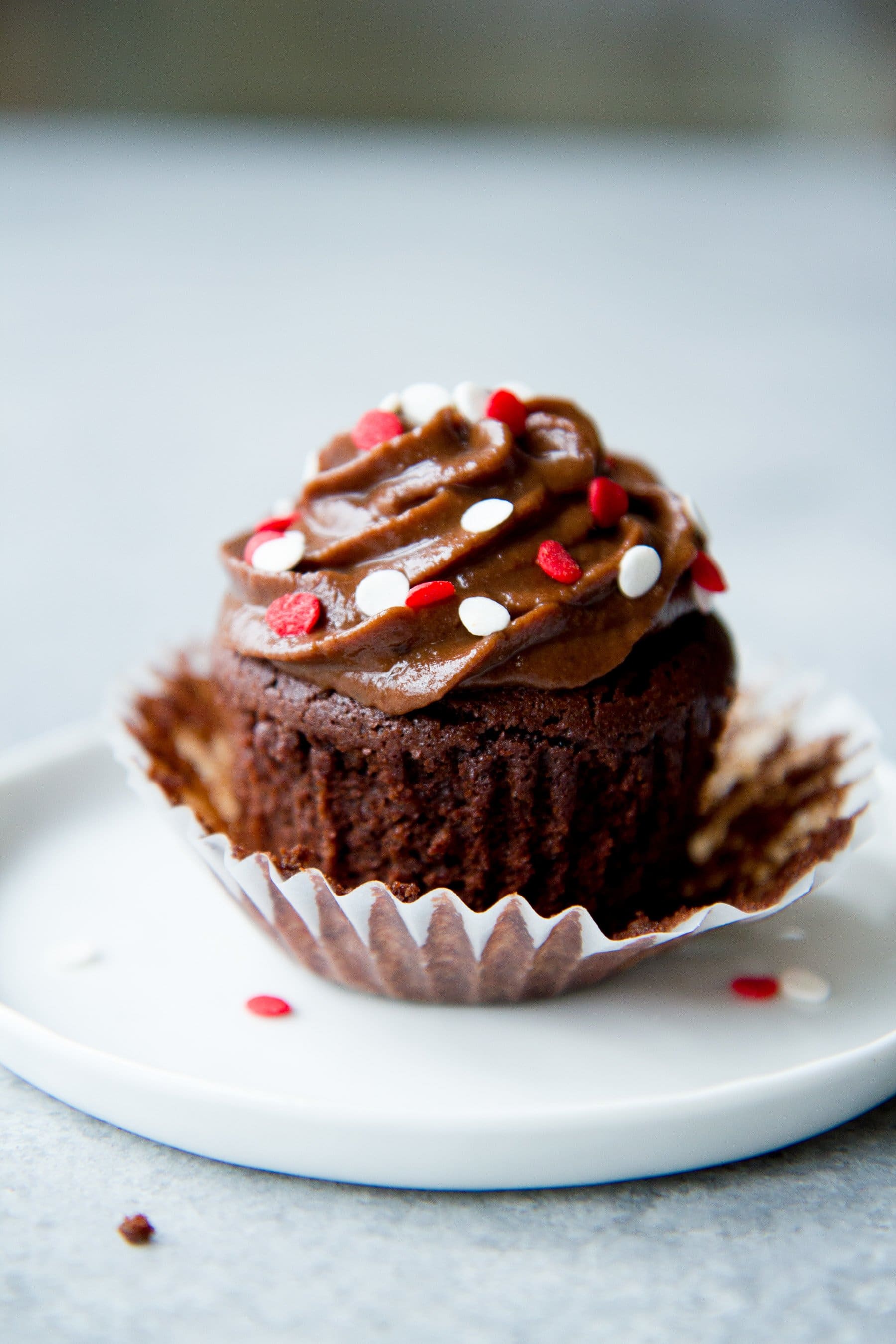 healthier chocolate cupcakes sits on a white plate.