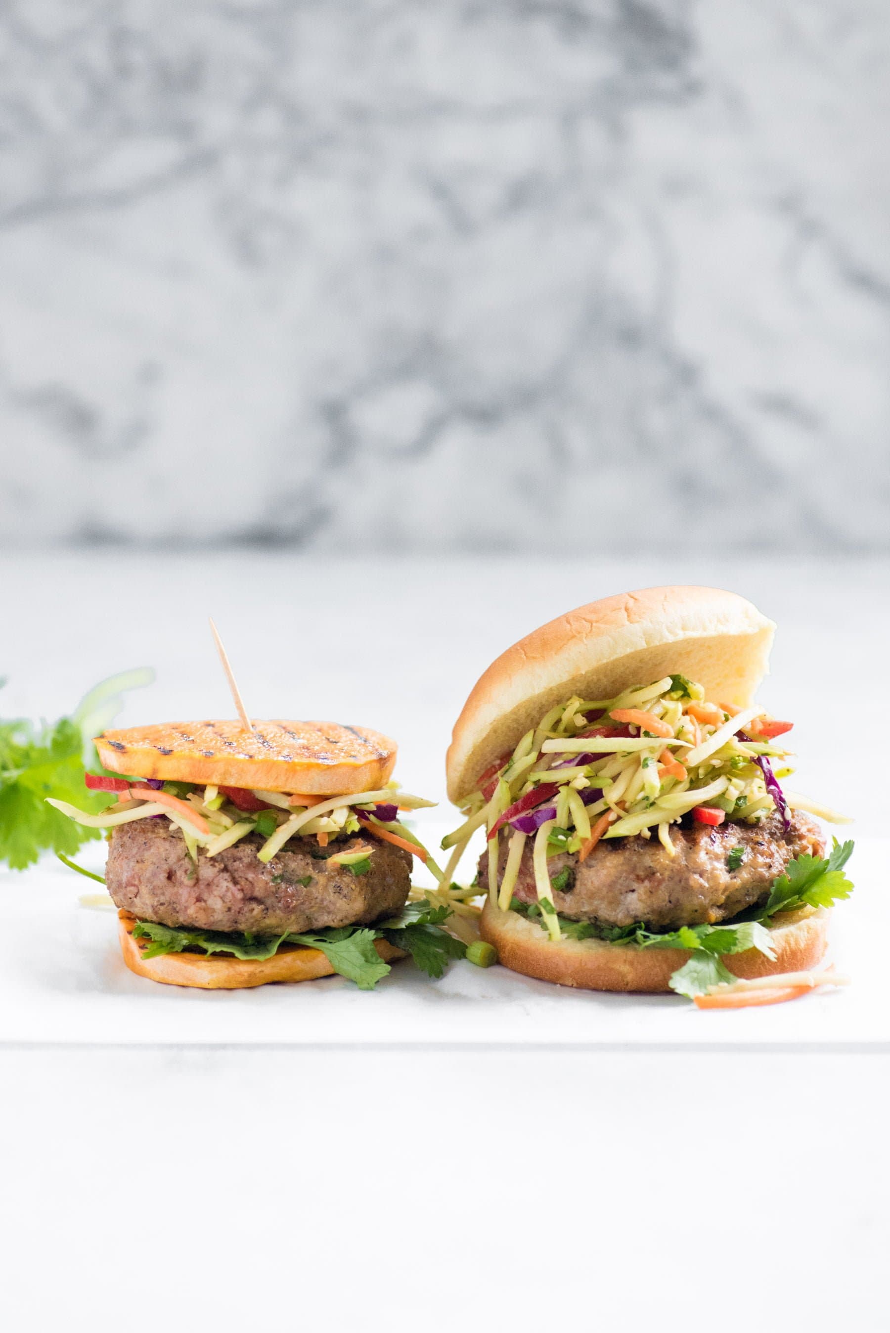two Asian Pork Burgers with Broccoli Slaw - One on Sweet Potato Rounds, One on Bun