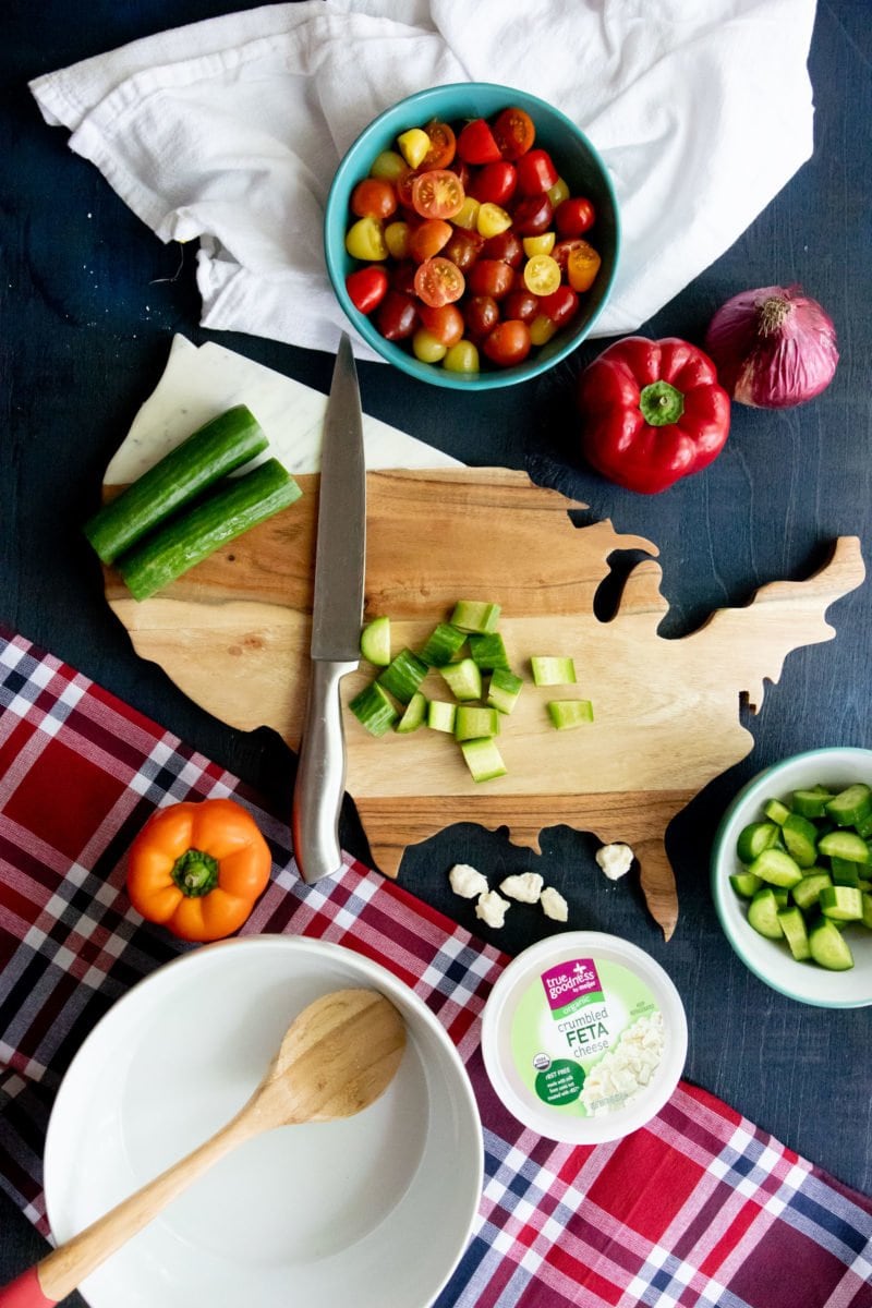 Overhead shot of chopped vegetables on a United States shaped cutting board