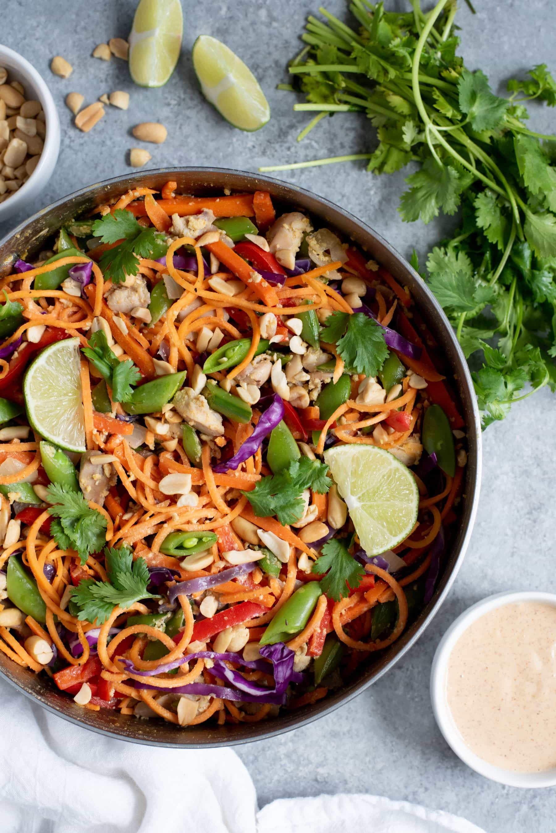 Overhead shot of Meal Prep Chicken Pad Thai with Sweet Potato Noodles in a metal dish