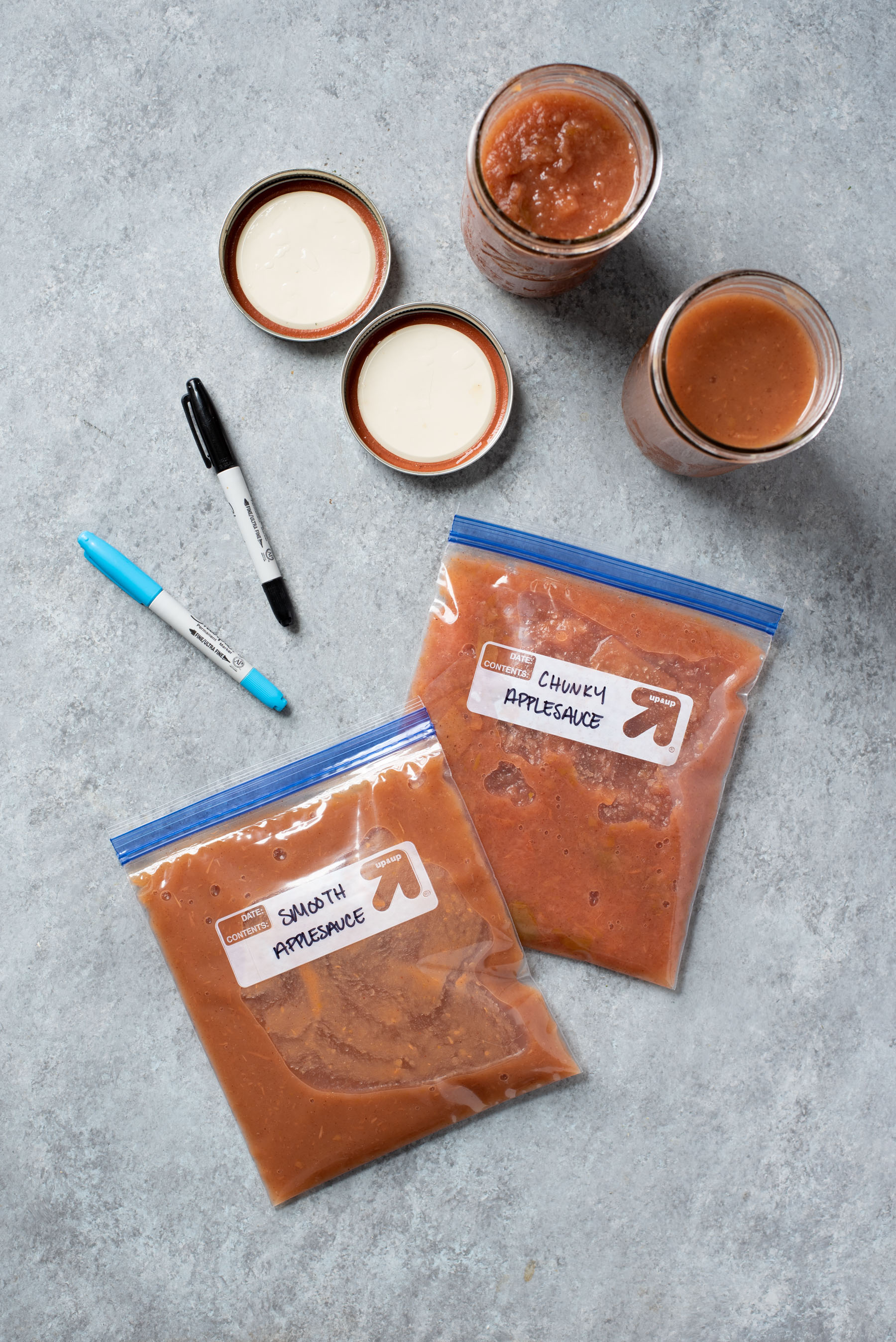 Instant Pot Applesauce packed into freezer bags and labeled with permanent markers