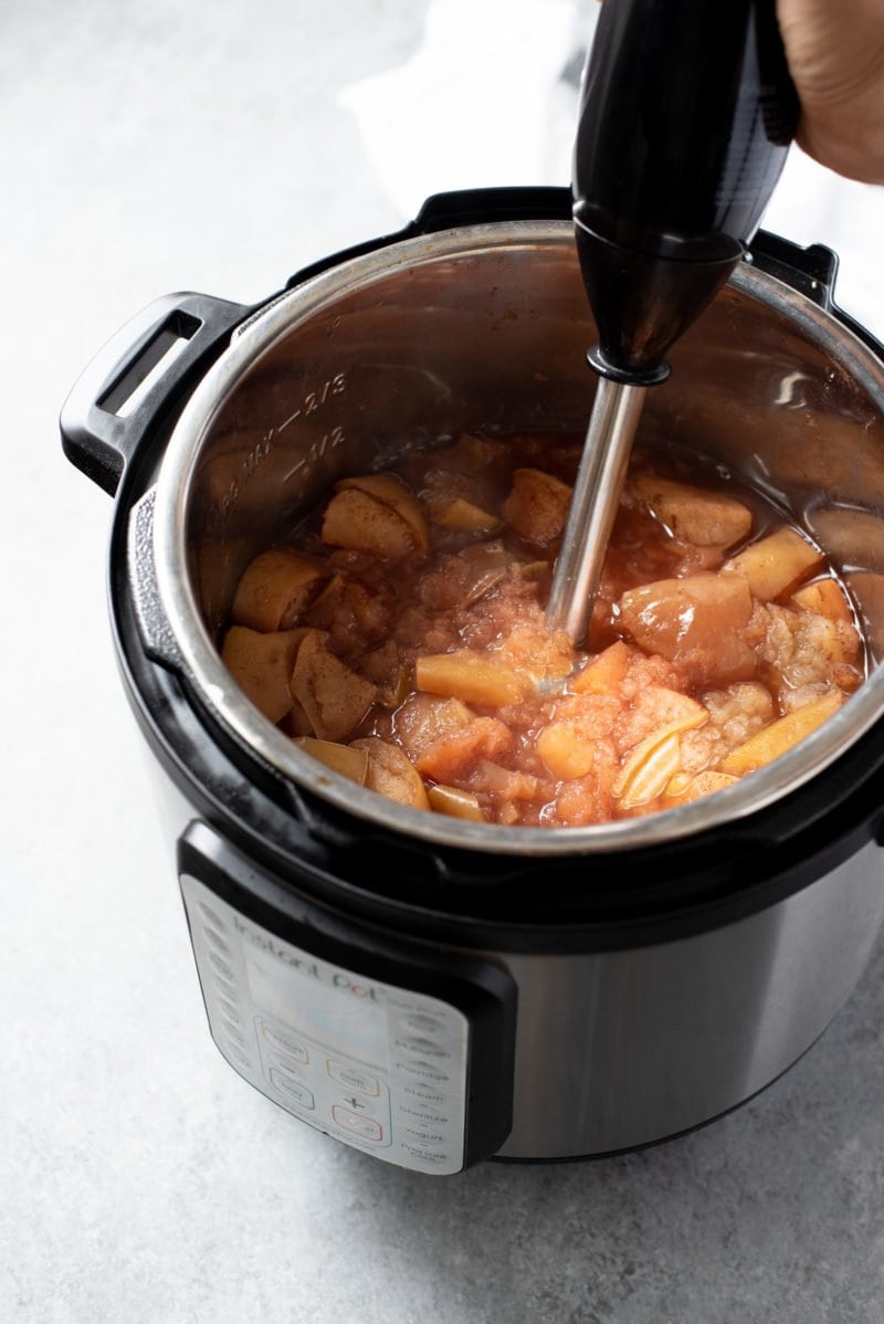 Immersion blender processing cooked apples in an Instant Pot