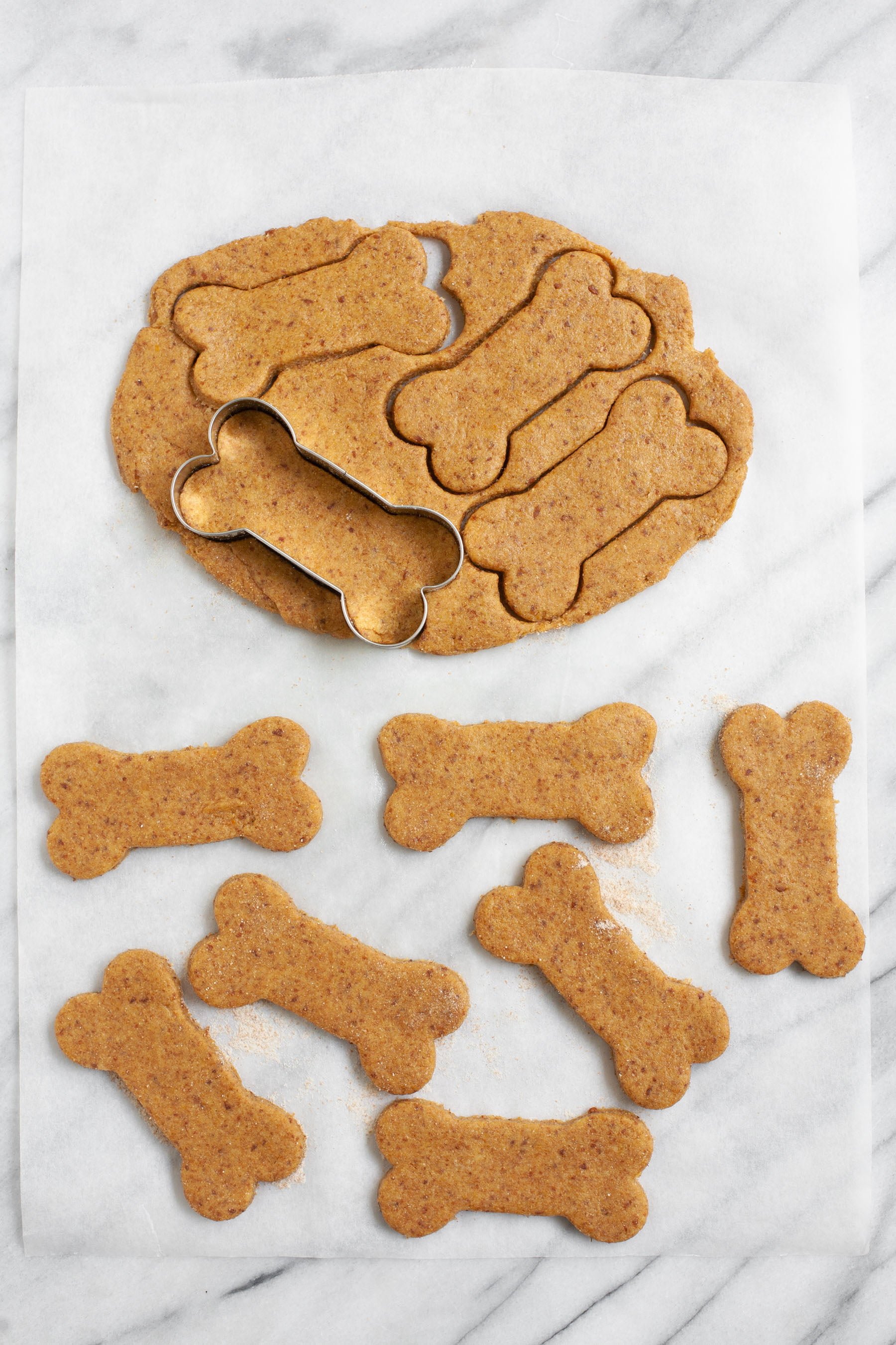 Cookie cutter cutting out bone shapes for Healthy Homemade Dog Treats