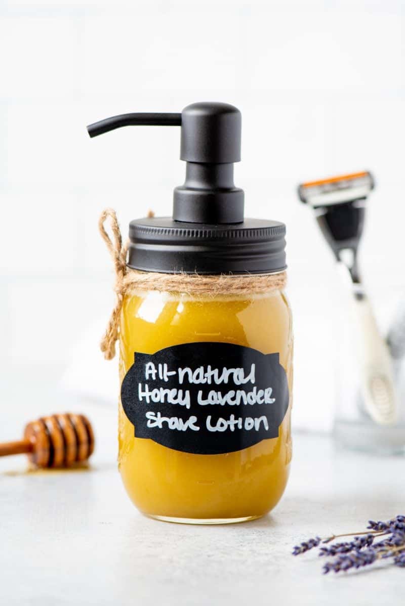 Shave lotion in a mason jar with a pump top. A hand-written label reads "All-Natural Honey Lavender Shave Lotion."