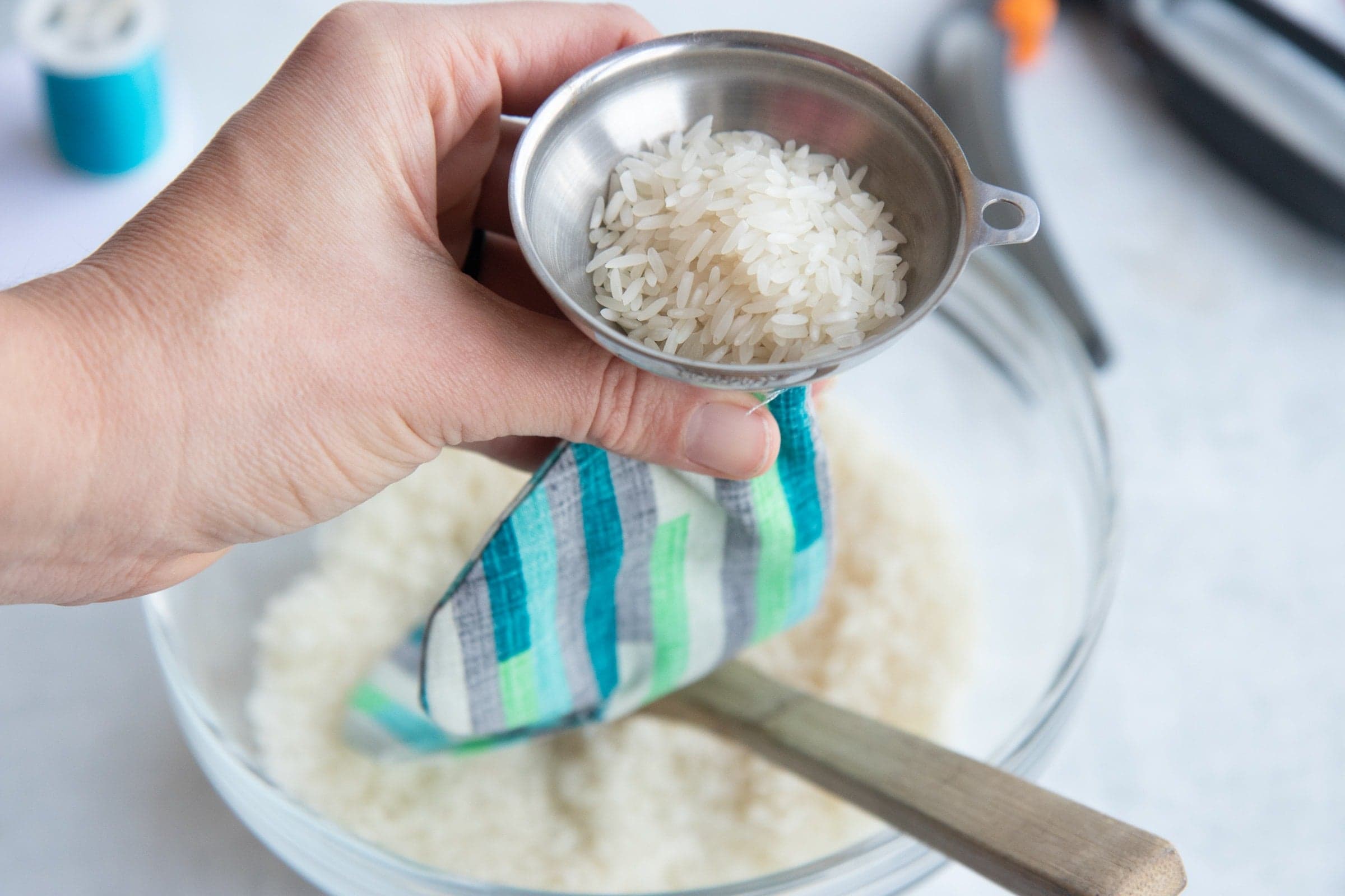 Rice in a funnel being poured into a Soothing Headache Eye Mask