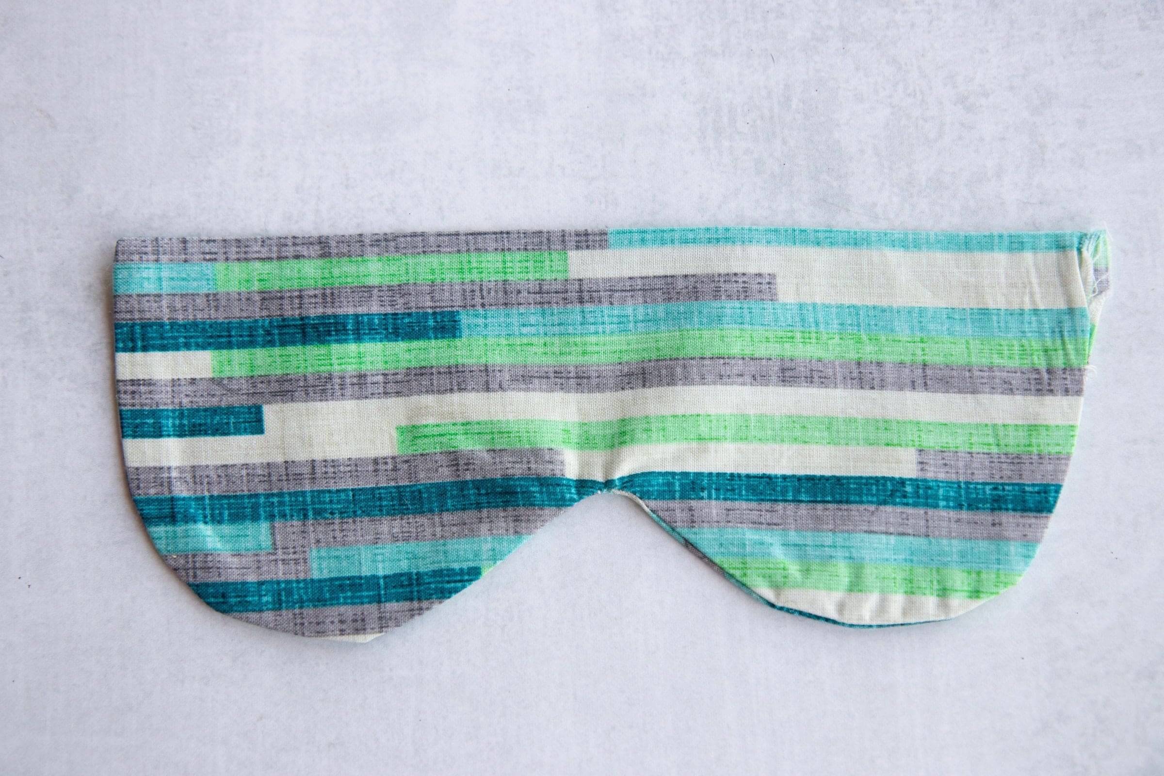 Blue, green, white, and grey Soothing Headache Eye Masks sewn together but unfilled