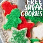 Grain-Free Paleo Sugar Cookies with Coconut Butter Frosting and Christmas sprinkles on a white platter. A text overlay reads "Grain Free Sugar Cookies."