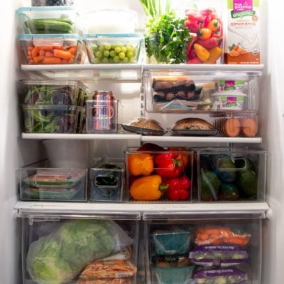 A clean, organized fridge filled mostly with produce