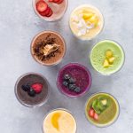 8 Healthy Smoothies Without Banana shown from overhead on a marbled background