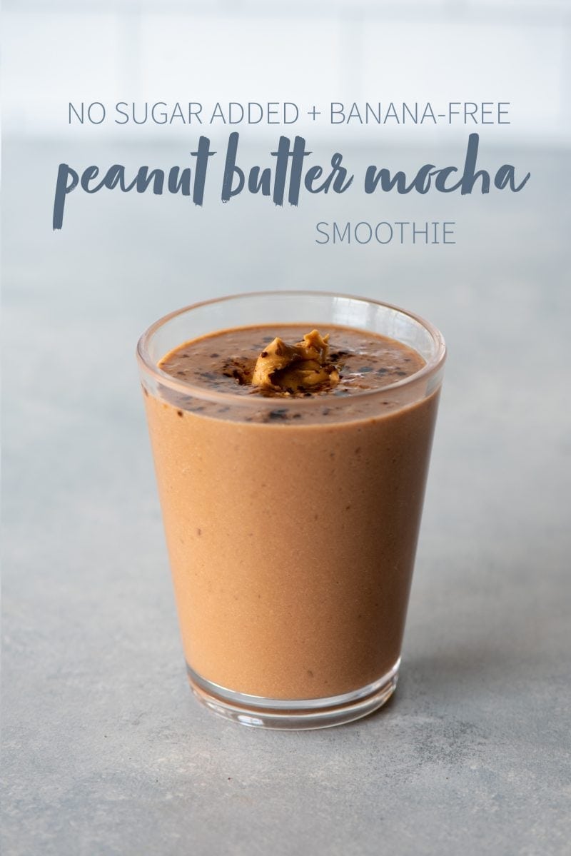 Peanut butter mocha smoothie in a clear glass topped with peanut butter. A text overlay reads "No Sugar Added + Banana-Free Peanut Butter Mocha Smoothie."
