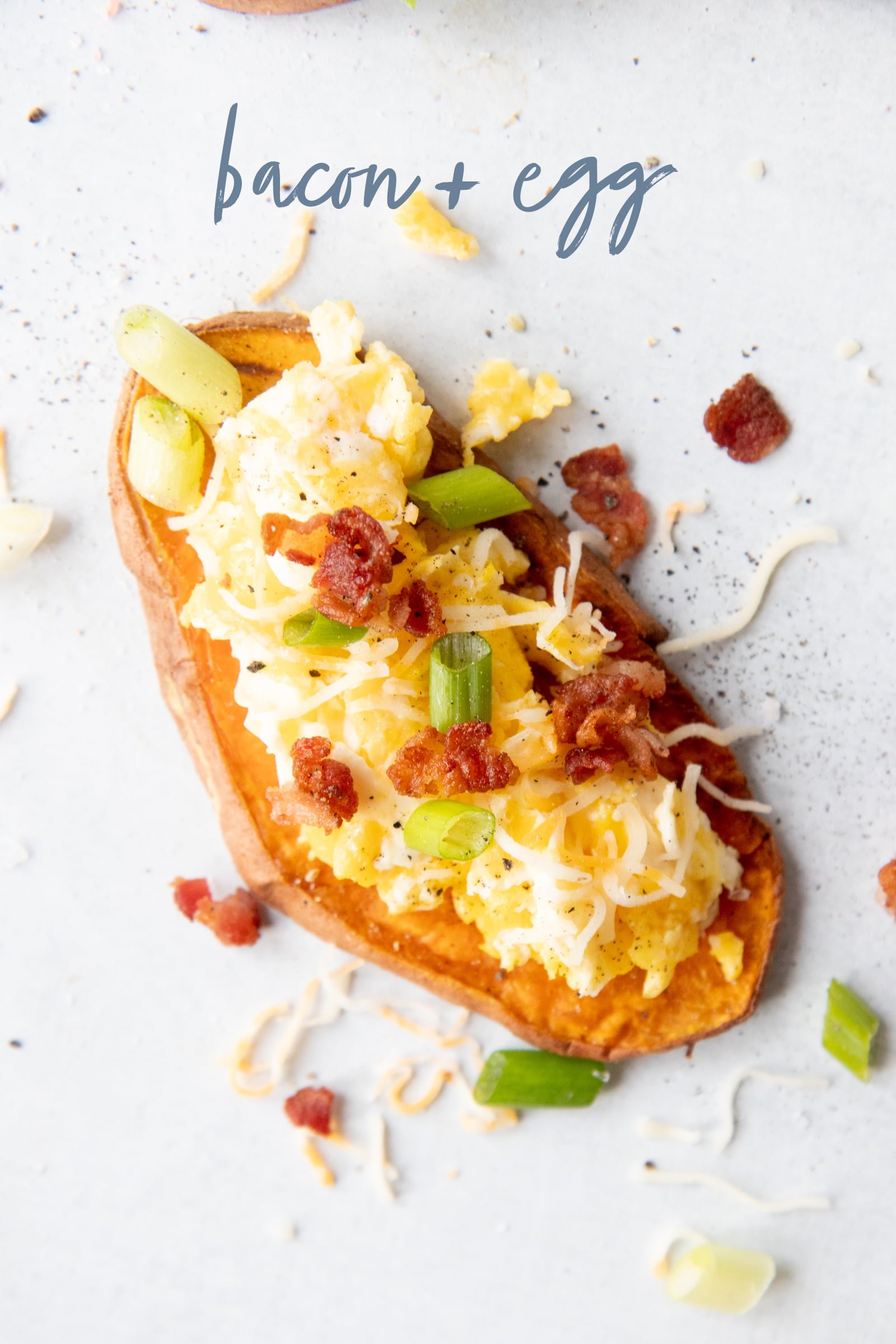 Sweet Potato Toast topped with scrambled eggs and bacon and green onions