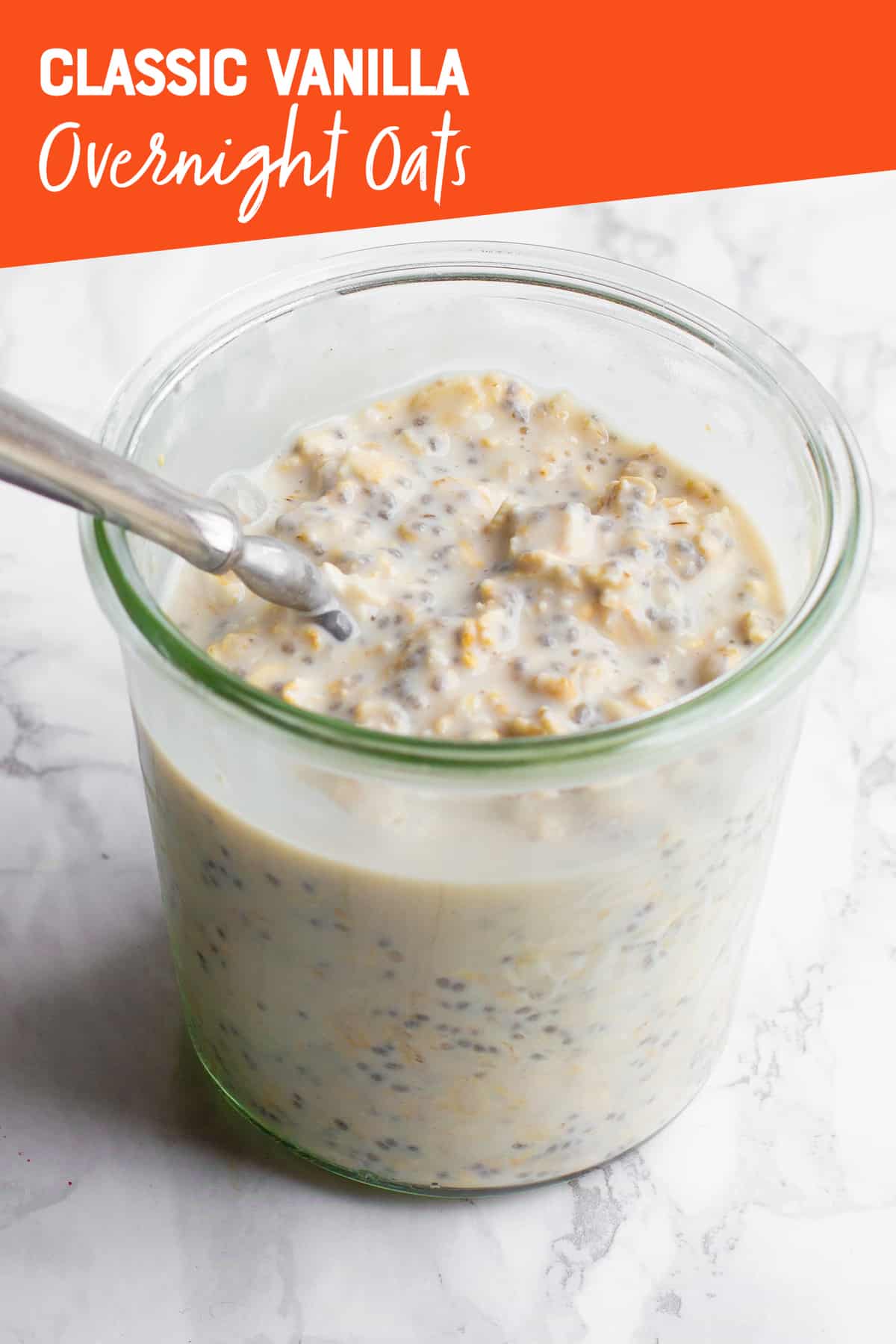 A clear glass jar filled with overnight oats, with a spoon sticking out. A text overlay reads "Classic Vanilla Overnight Oats."