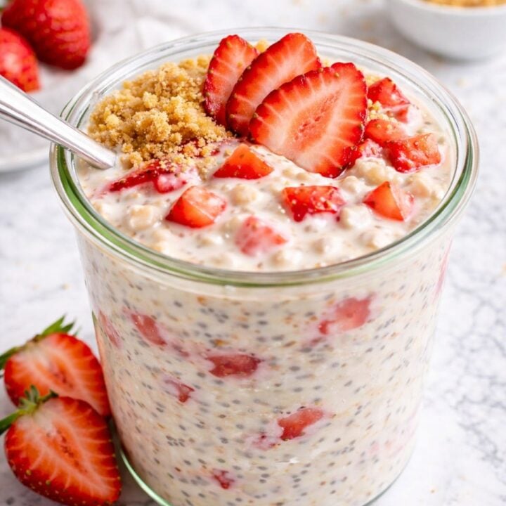 A jar of strawberry cheesecake overnight oats on a countertop