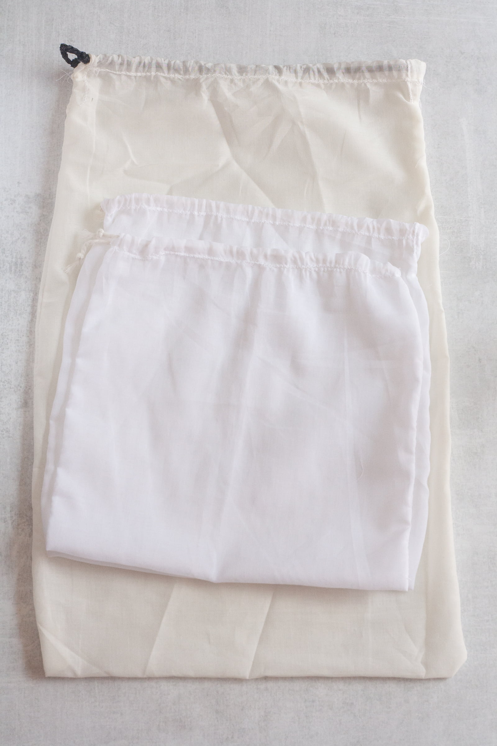 Three cotton voile drawstring bags stacked on top of each other
