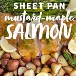 Sheet pan with a silicon baking sheet covered with roasted salmon, asparagus, potatoes, fresh lemon slices and herbs. A text overlay reads, "Sheet Pan Mustard-Maple Salmon."