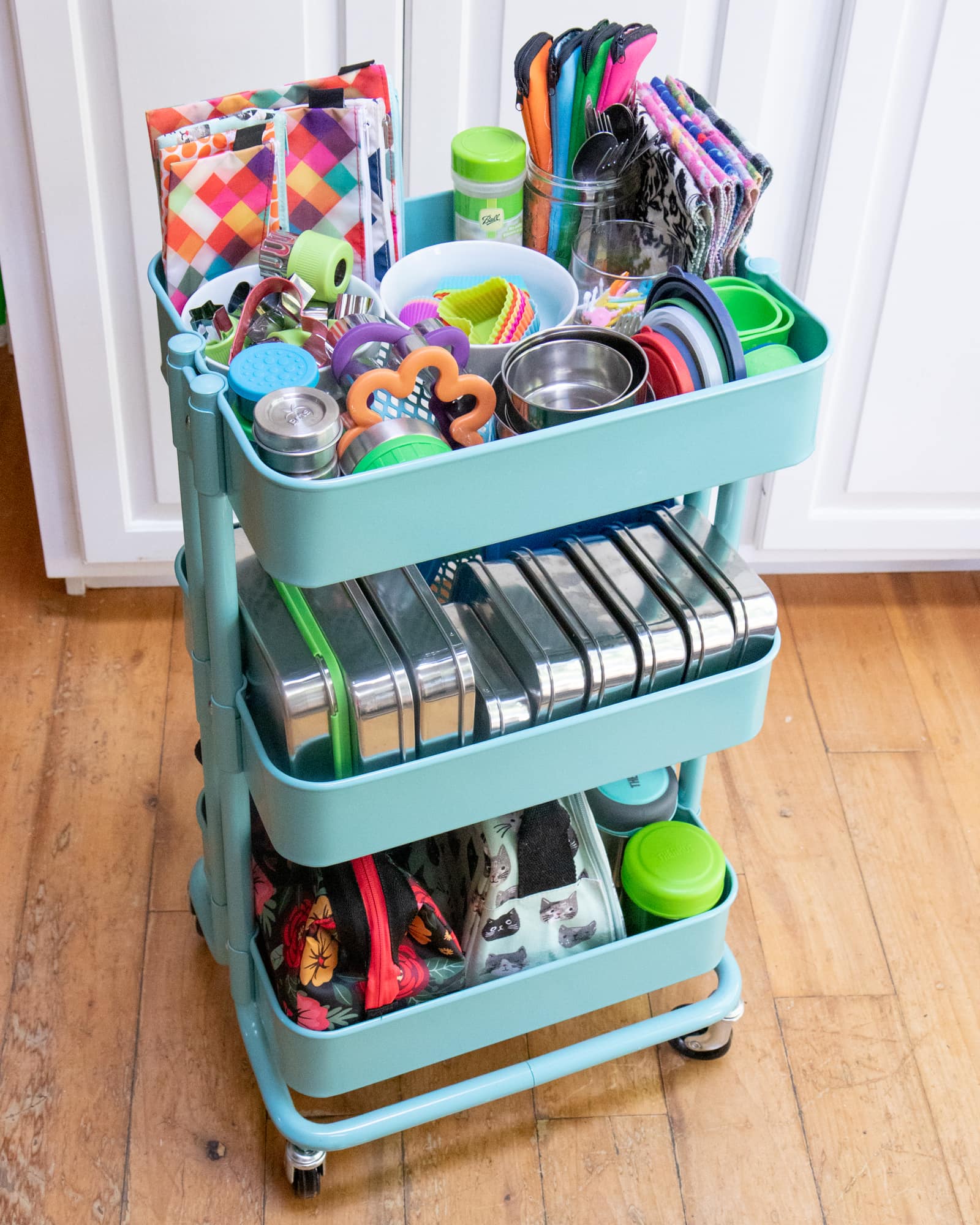 Rolling utility cart filled with tools and materials for packing zero-waste lunches.