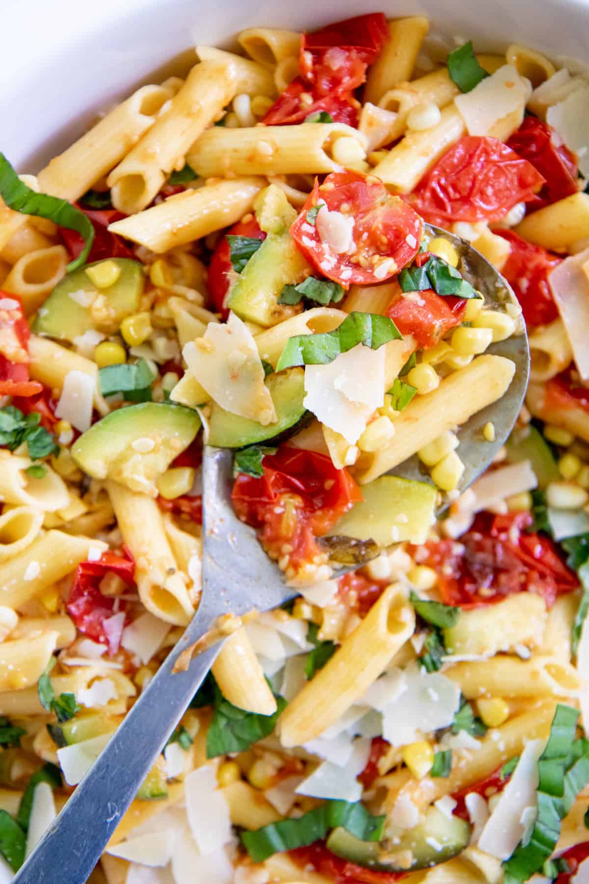 Close up of Summer Roasted Vegetable Pasta with a spoon scooping some out.