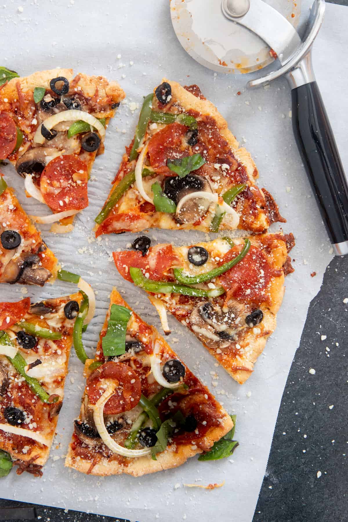 Sliced veggie pizza on an almond flour pizza crust.