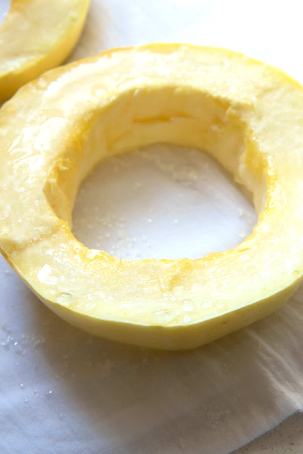 Close up of the water on a salted spaghetti squash ring.